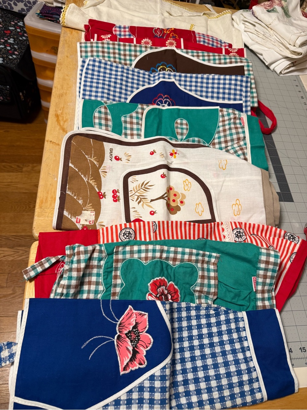 collection of vintage-style aprons with various checkered and floral patterns.